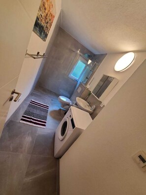Shower, towels, soap, toilet paper