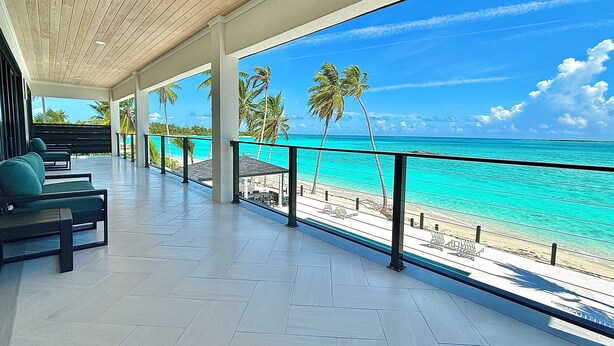 A covered outdoor area with a view of the beach and ocean. - KPOW on the Beach - Brand New 5 bedroom Luxury Beachfront House! (Steventon)