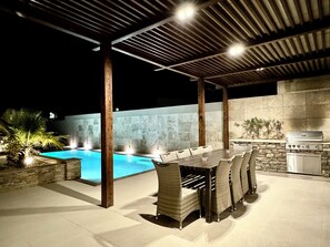 An outdoor patio with a pool, a dining area with wicker chairs, a stone wall, and a grill. - Luxurious villa in a tranquil hamlet - 6 bedrooms with ensuite bathrooms & ACs (Kerċem)
