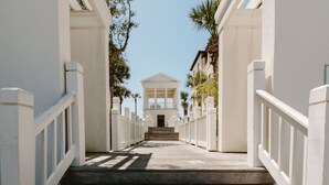 A staircase leading to a building with a white facade and a central entrance.