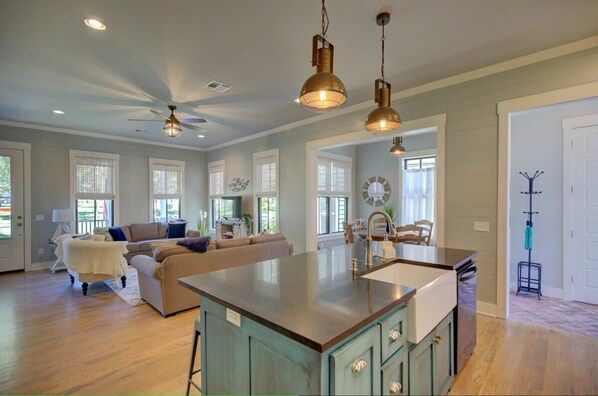 A spacious kitchen with a large island, pendant lighting, and a ceiling fan. - Watercolor Cottage (Carlton Landing)