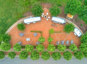 An aerial view of a campsite with two RVs, a picnic table, and a barbecue grill. - Watercolor Cottage (Carlton Landing)