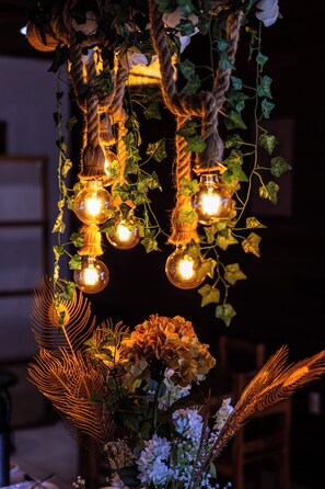 A chandelier with multiple bulbs and vines.
