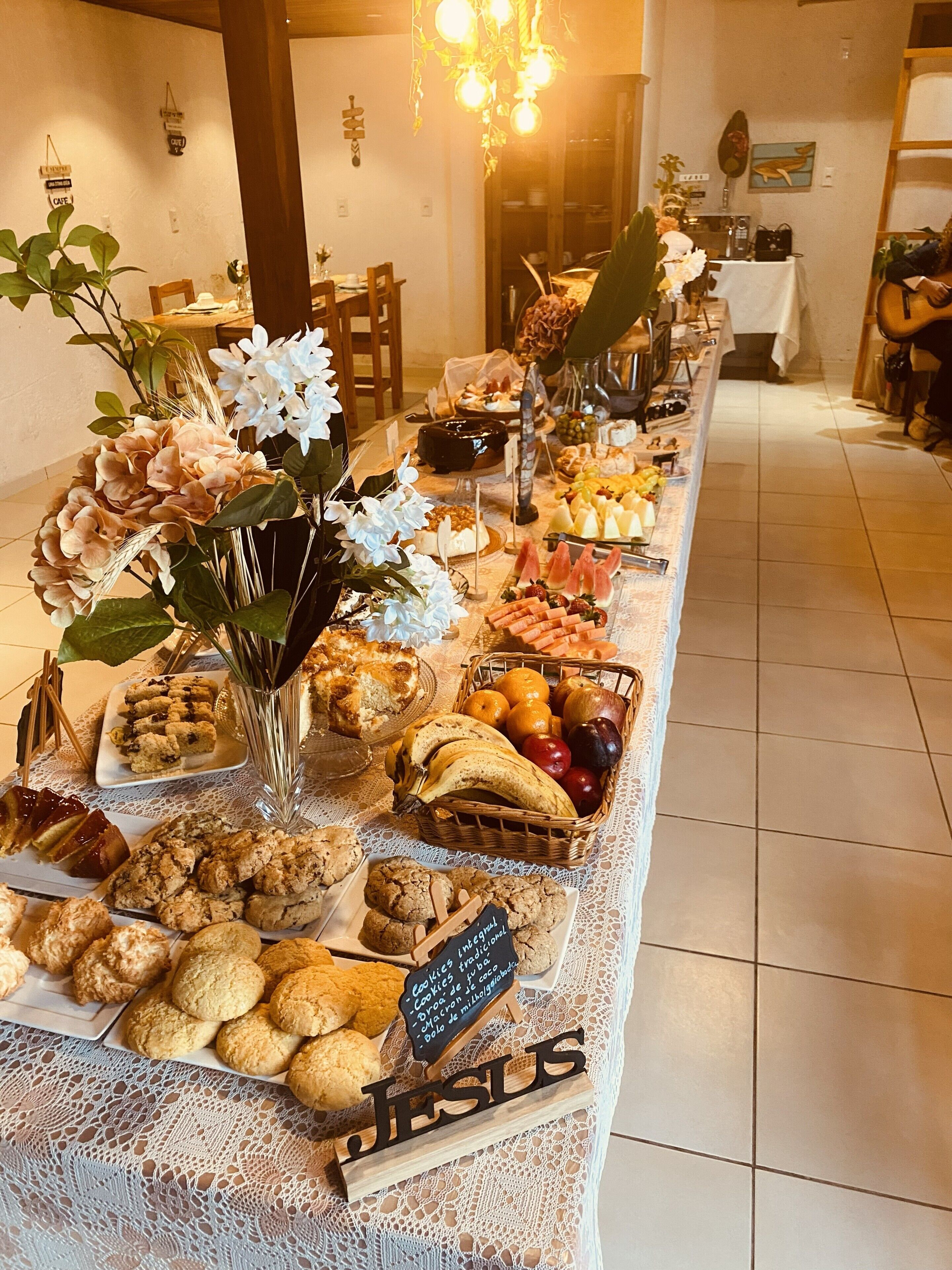 A buffet table with various food items and a sign indicating 'Cookies from the bakery'.