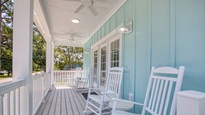 A covered porch with white rocking chairs and a white trash can. - Beach Home! Private Pool! Arcade-Beach-FUN! Elevator (Murrells Inlet)