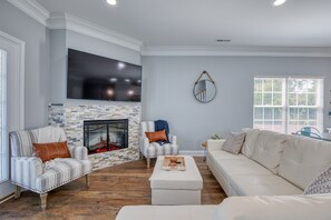 Cozy seating area with fireplace, flat-screen TV, and comfortable seating for relaxation.