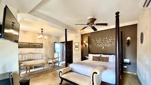 A spacious bedroom with a large bed, a ceiling fan, a TV, and a seating area with a sofa and chairs. - 8APS-4 CASA ANTIGUA EN EL CENTRO HISTORI (Cartagena)
