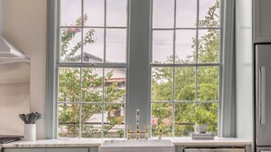 A kitchen with a large window, stainless steel appliances, and light gray cabinets. - The Manor 93 - B Beautiful Three Bed Three Bath Close to King St. (Charleston)
