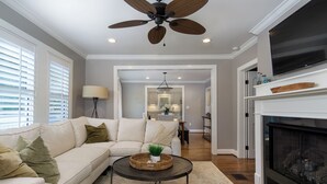 A living room with a sofa, coffee table, and fireplace. - View Street Retreat | Pet Friendly, Fenced Yard, Walk to Town! (Black Mountain)