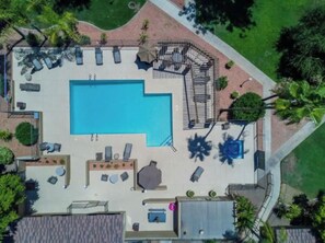 An aerial view of a swimming pool area with sun loungers, a hot tub, and a small deck area. - ++PRIME LOCATION++ Cozy Condo in Phoenix Arcadia Lite Area. (Phoenix)