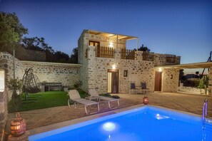 A stone building with a pool, outdoor seating, and a well-lit entrance. - Stoney Villa Koxari By Estia (Hersonissos)