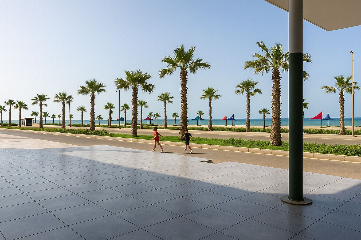 A paved walkway with palm trees and a view of the sea.