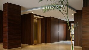 A modern interior with a staircase, wooden panel walls, and a potted plant. - Simple & Serene Chalet (Port Said Governorate)