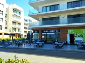 A modern building with a coffee shop named "DOAYA COFFEE" on the ground floor. - Beachfront Chalet in Porto Said with (Port Said Governorate)