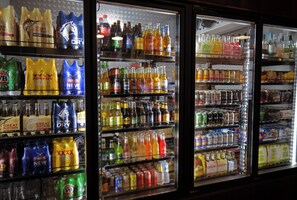 A refrigerated display case filled with various beverages and snacks. - Royal Hotel Guyra (Guyra)