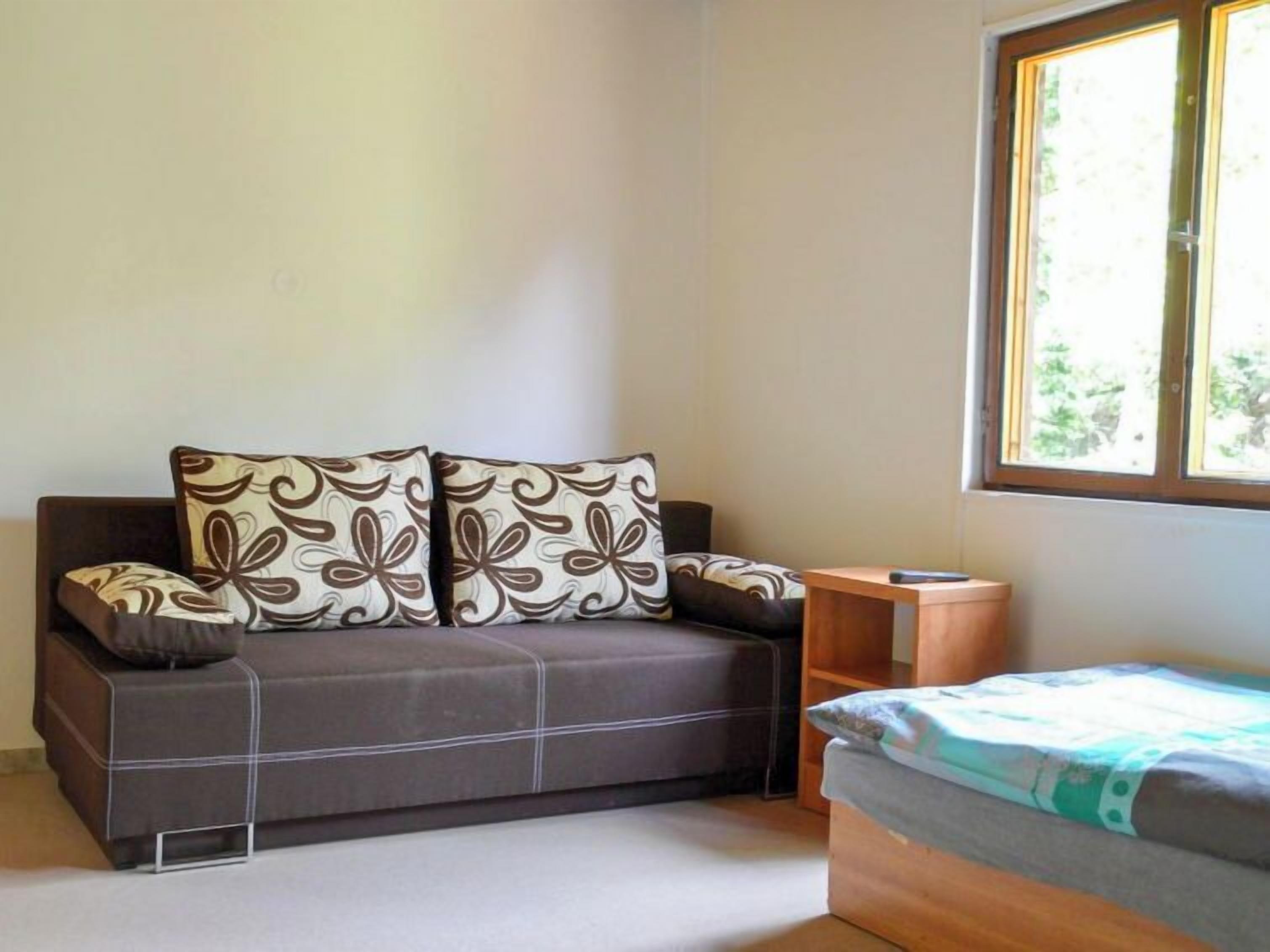 A small, compact room with a sofa and a small table.