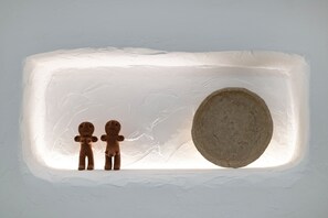 A rectangular ice sculpture with two figures and a large oval shape.