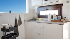 A modern kitchen with a built-in microwave, a sink, and a window above the counter. - Studio 'Apartment La Higuera' with Sea View, Wi-Fi, and Air Conditioning (Arrecife)