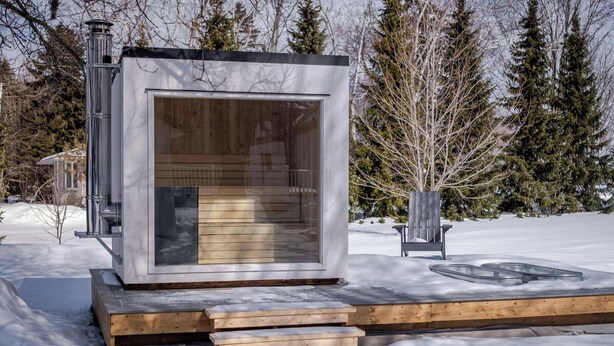 A modern, insulated cabin with a large window, wooden steps, and a metal chimney. - Luxe Sandbanks Resort w Hot Tub, Sauna, Plungepool (Prince Edward)