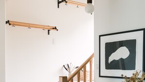 A staircase with wooden steps and a black cabinet with drawers. - Starbase - Waterfront Home w Pickleball Court (Prince Edward)