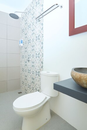A bathroom with a toilet, a shower, and a sink with a stone basin. - Attara Inn Senggigi (Senggigi)