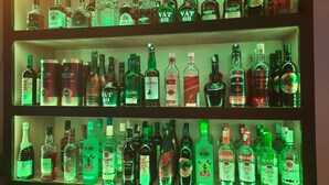 A bar with multiple shelves of liquor bottles. - Hotel Royal Palace (Port Blair)