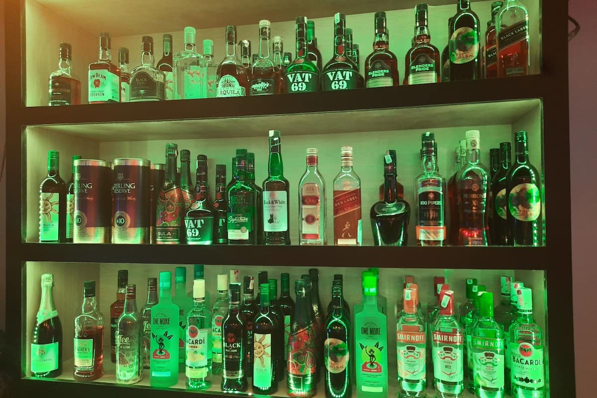 A bar with multiple shelves of liquor bottles.