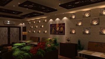 A modern interior with a central seating area, decorative ceiling panels, and wall-mounted lighting.