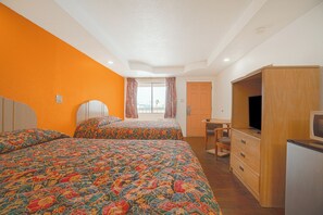 A bedroom with two beds, a wooden wardrobe, a television, and a window with curtains. - Budget Inn By Oyo Corpus Christi Beach (Portland)