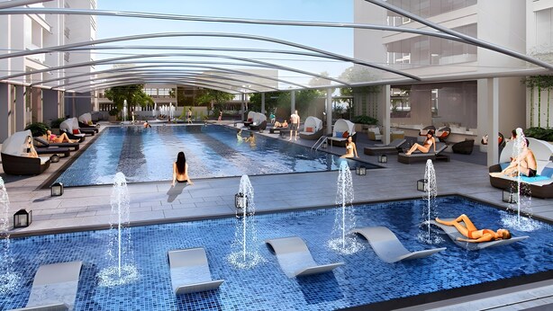 Ein moderner Poolbereich mit mehreren Liegebereichen und Wasserspielen.