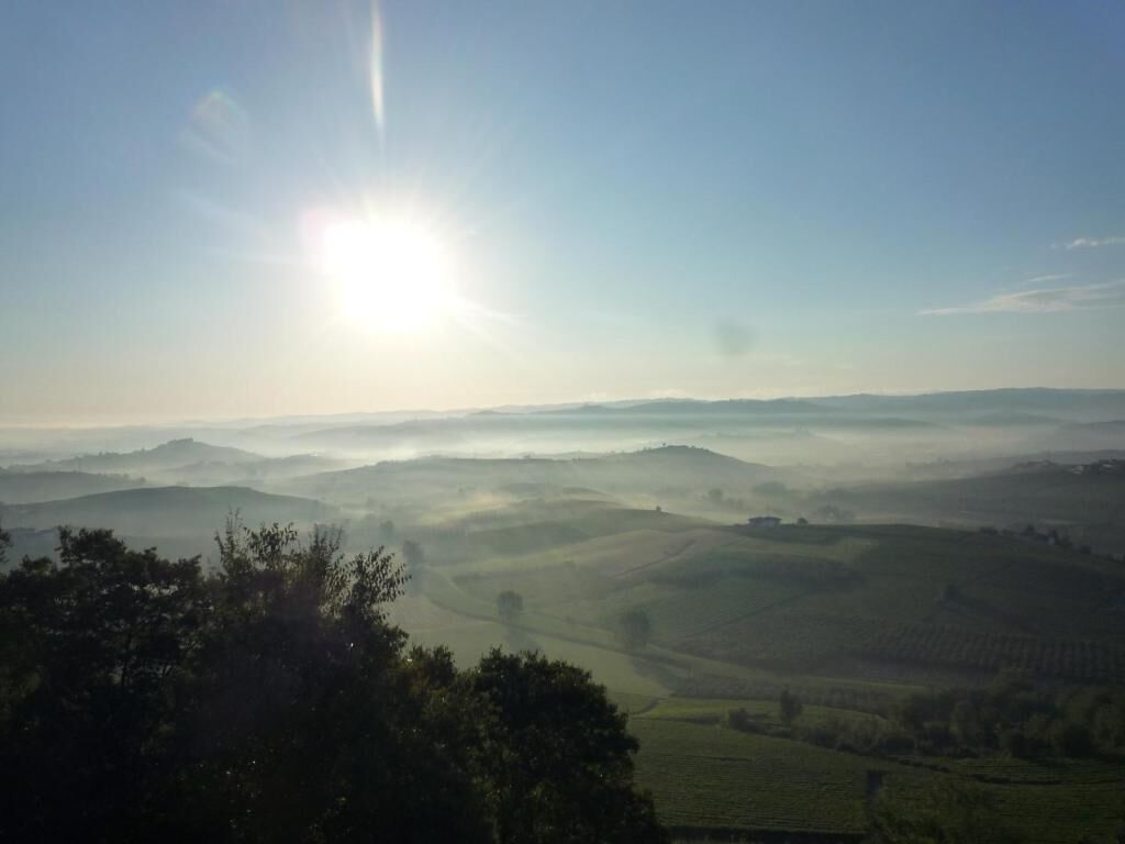 A landscape with rolling hills and a clear sky.