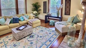 A well-lit living room with a sofa set, a coffee table, and a patterned rug. - 2 Bedroom Suite in Historic B&B, Breakfast Include (Eureka Springs)