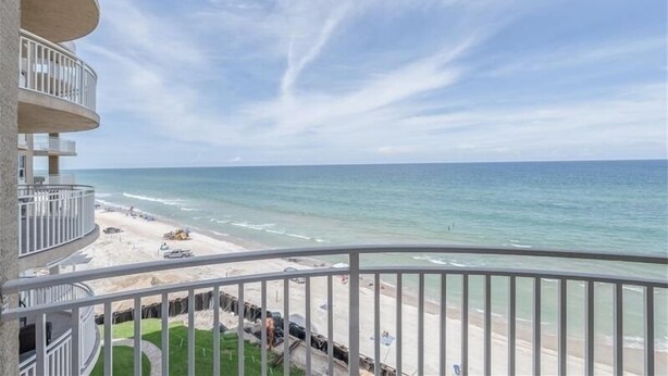A balcony with a view of the beach and ocean. - 705 St Maarten - Daytona Beach Oceanfront Vacations, Inc (Daytona Beach Shores)