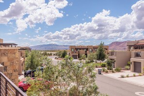 Residential area with modern architecture, surrounded by lush vegetation and scenic views.