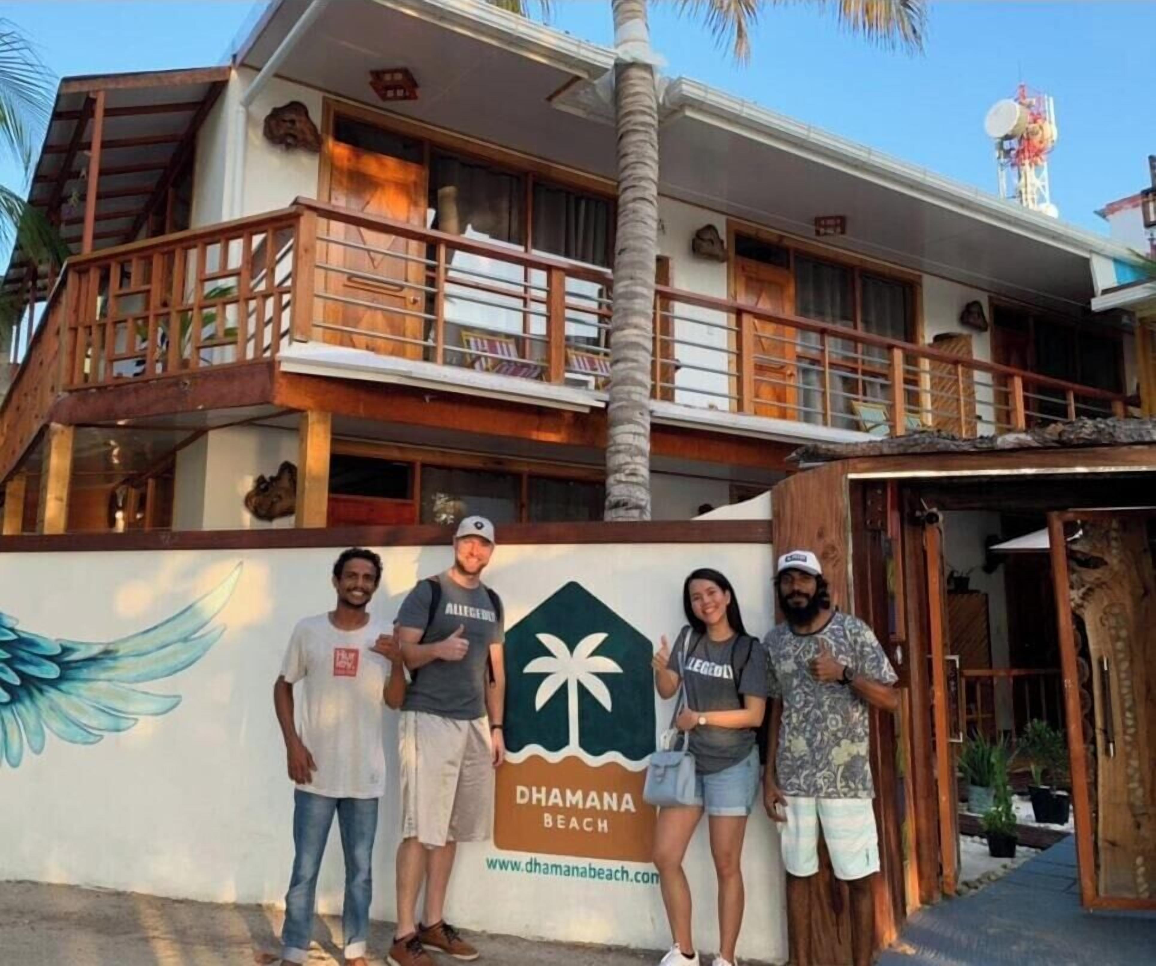 A multi-story building with a sign for Dhama Beach.