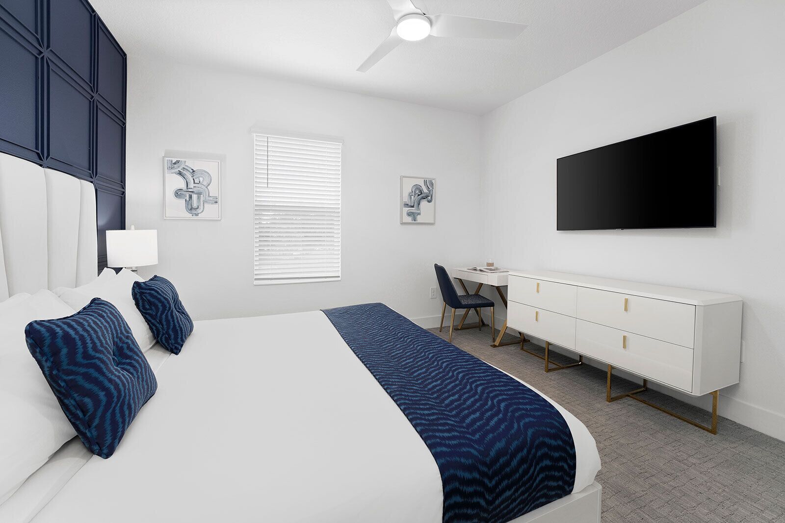 A modern bedroom with a bed, desk, and TV.