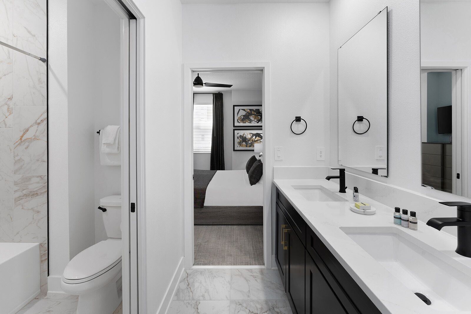 A modern bathroom with a toilet, sink, and shower.
