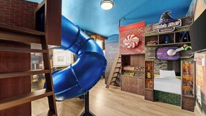 A children's play area with a blue slide, a hat shop, and a candy store. - Wondrous Wonderland | A dream escape on I-Drive - theme RMs, PVT pool, theater (Orlando)