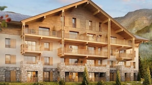 A multi-story wooden building with balconies, stone foundation, and a mountainous backdrop.