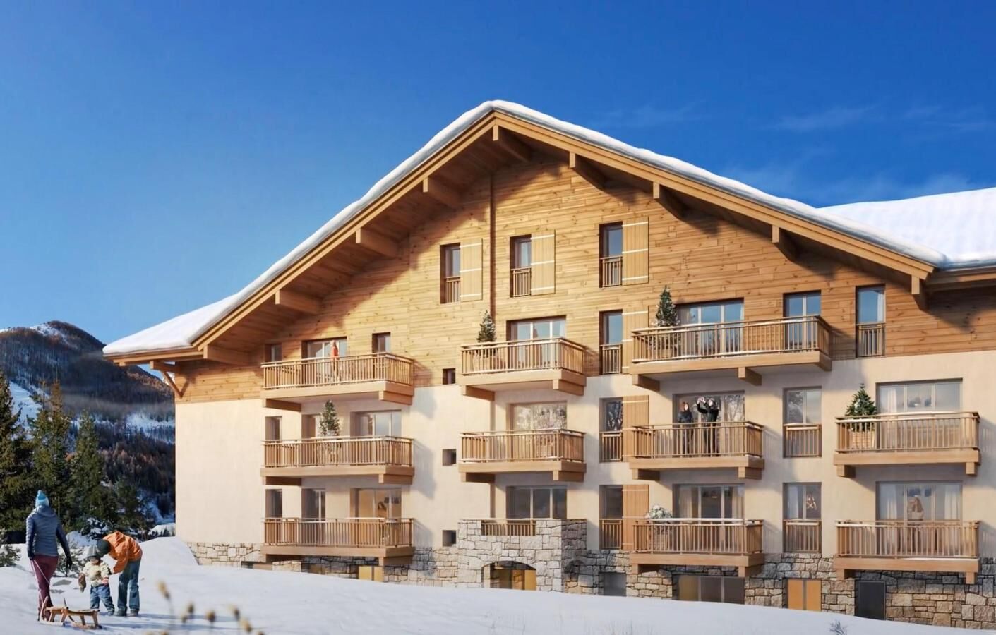 A multi-story wooden building with balconies, set against a snowy mountain backdrop.