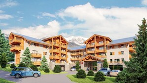 A multi-story hotel with balconies, a stone facade, and a mountainous backdrop. - Wifi, 100m from ski slopes, swimming pool, sauna, hammam, tv, ski locker, 57m², Auron (Auron)