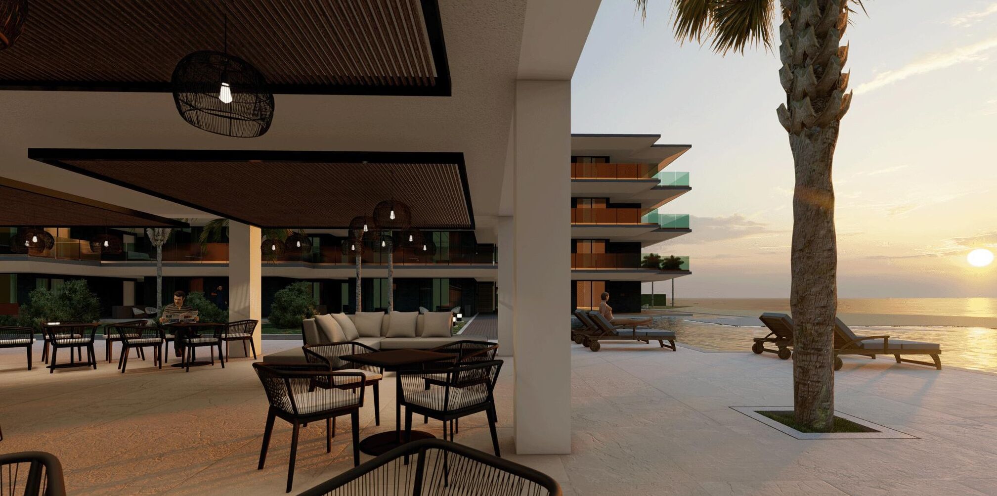 A modern resort with outdoor seating, a pool, and a view of the ocean at sunset.