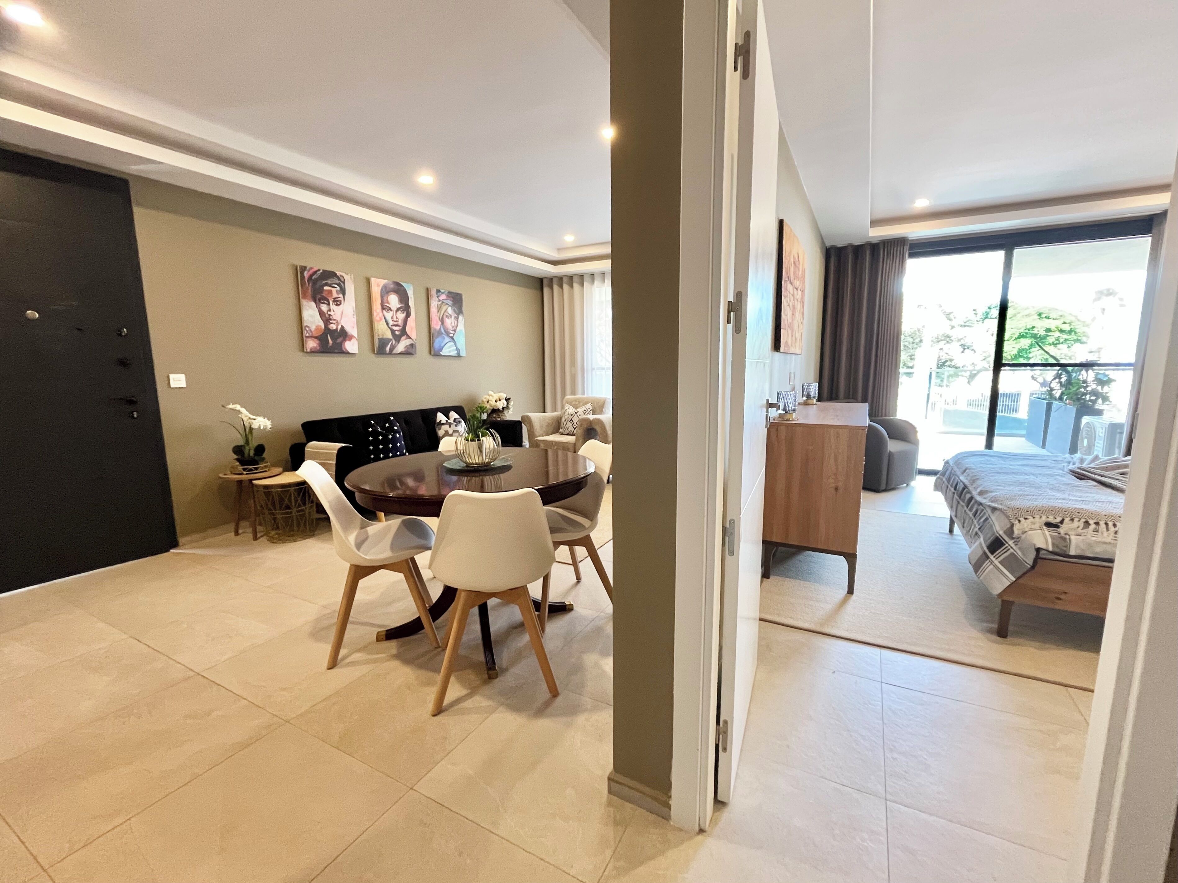 Un salon moderne comprenant un coin repas, un canapé, un lit et une vue sur l’extérieur.