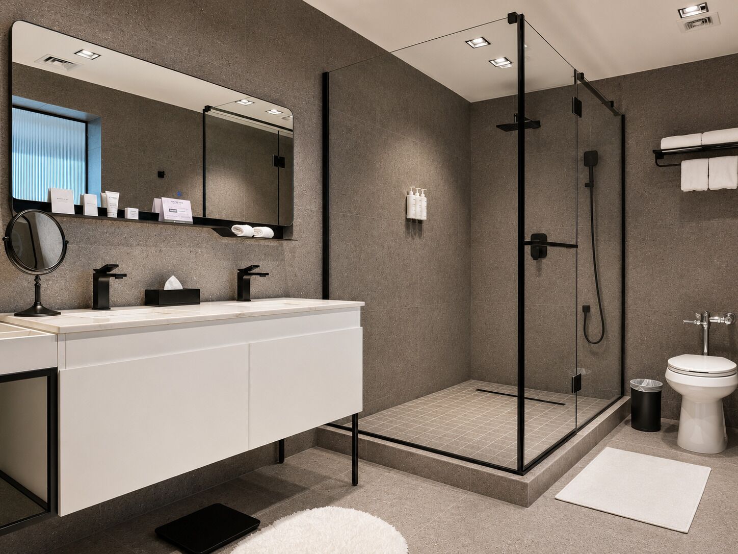 Une salle de bain moderne avec une douche à parois de verre, un meuble-lavabo blanc avec un miroir et des toilettes.