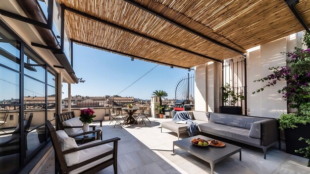 A modern outdoor living area with a sofa, chairs, a table, and a dining table. - Modern Luxury Penthouse with Terrace (Roma)
