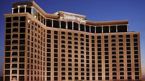 A multi-story hotel with a prominent sign reading "Beau Rivage."