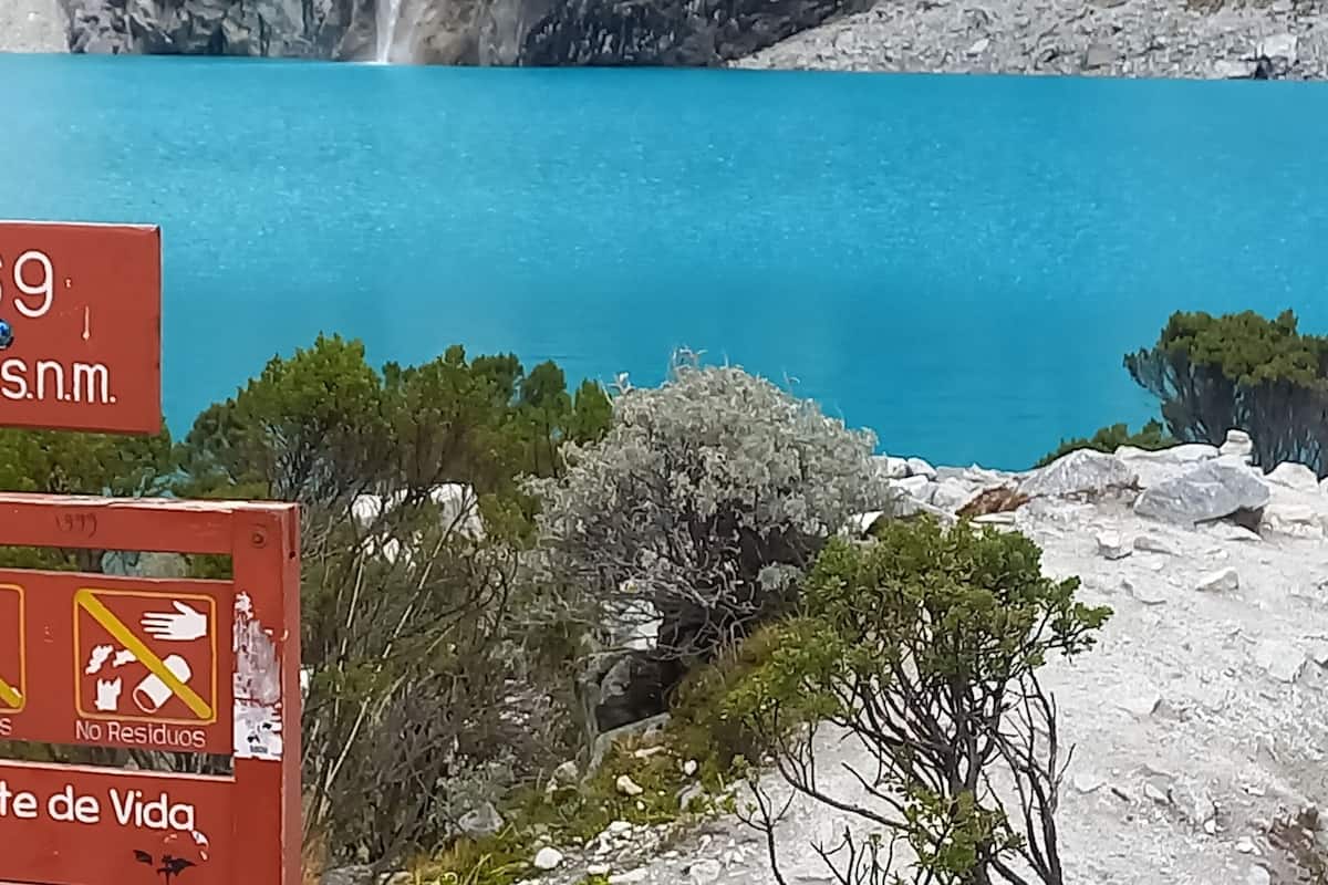Un panneau représentant une montagne et de l’eau, indiquant un lieu situé à Lag.69, à 4 604 m d’altitude. Le panneau comporte également des symboles de protection de l’environnement et un message en espagnol sur le fait que la nature est une source de vie.