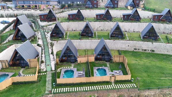 A modern resort with triangular-roof cabins arranged in rows, each with a private pool and outdoor seating area. - Aronia Bungalow (Yalova)