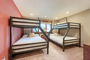 Two bunk beds with a window view, a wooden nightstand, and a carpeted floor. - 2430 Ultimate Deer Valley Getaway Hot Tub and 2 Gold  Utah Ski Passes (Park City)