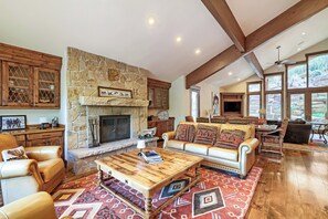 A spacious living room with a stone fireplace, leather sofas, and a wooden coffee table. - 2430 Ultimate Deer Valley Getaway Hot Tub and 2 Gold Utah Ski Passes (Park City)